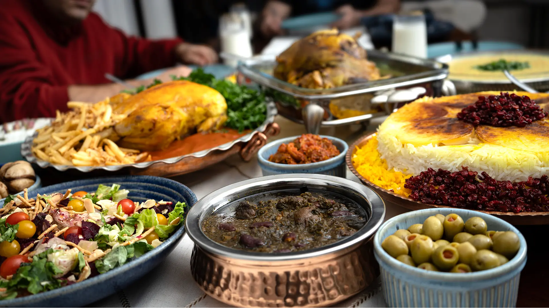 A dinner table covered with persian food.